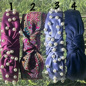 May include: Four different headbands with pearl embellishments. The headbands are in purple, blue, and a multi-colored patterned fabric.
