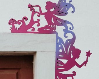 May include: A pair of fairy corner brackets made of wood, painted in a gradient of pink and purple. The fairies are holding stars and are surrounded by floral designs.