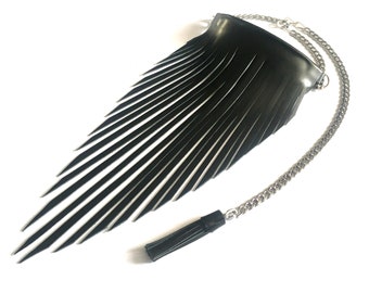 May include: A black leather fringe bag with a silver chain strap and a black tassel. The bag has a triangular shape with a pointed bottom and a wide top.