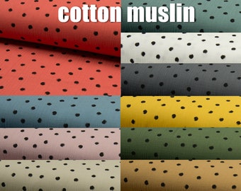 May include: A collection of cotton muslin fabric swatches with black polka dots in various colours, including coral, teal, blush, beige, grey, yellow, and green. The fabric is soft and lightweight, making it ideal for sewing projects such as baby blankets, clothing, and accessories.