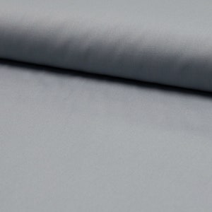 May include: A close-up of a light blue fabric with a smooth texture.