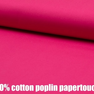 May include: Close-up of a bright pink fabric with a smooth texture. The fabric is 100% cotton poplin papertouch.