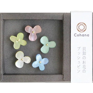 May include: A set of five pastel-colored flower-shaped push pins in a gray box. The box has a label that reads "Cohan". The label also has Japanese text that reads "Flower of the Season Push Pins".