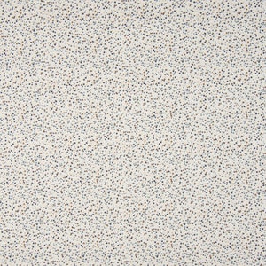 Op de afbeelding: Een witte stof met een verspreid patroon van kleine blauwe en bruine stippen.