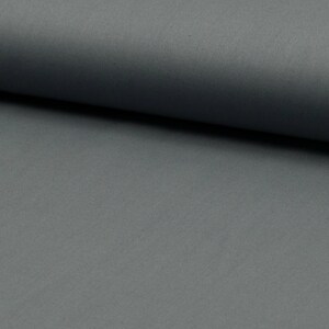 May include: A close-up of a smooth, dark gray fabric. The fabric has a subtle sheen and a slightly textured surface.