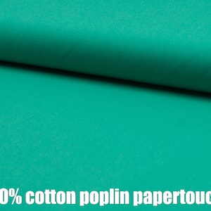May include: A close-up of a bright teal green fabric. The fabric is 100% cotton poplin papertouch.