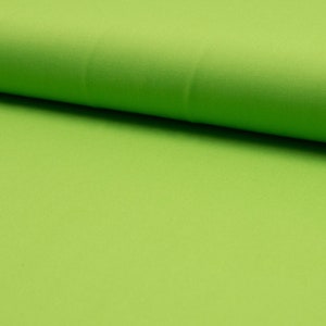May include: A close-up of a bright green fabric. The fabric has a smooth, slightly shiny texture.