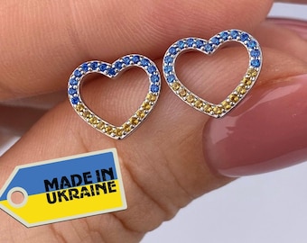 May include: A pair of silver heart-shaped earrings with blue and yellow gemstones. The earrings are made in Ukraine, as indicated by the tag in the image. "MADE IN UKRAINE" is written on the tag.