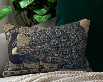 May include: A decorative pillow with a blue and green peacock design. The pillow is on a white couch with a green throw pillow behind it.