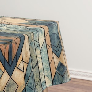 May include: A geometric patterned tablecloth featuring a design of intersecting lines and shapes in shades of blue, tan, and orange. The design has a stained glass appearance, with dark lines separating the shapes. The tablecloth is draped over a table.