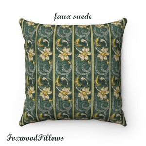 May include: A green and yellow floral patterned cushion with the text "faux suede" printed on the top. The cushion is made of a soft, faux suede fabric.