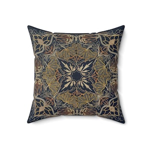 May include: A navy blue throw pillow with a gold and orange floral pattern. The pillow has a square shape and a soft, plush texture.