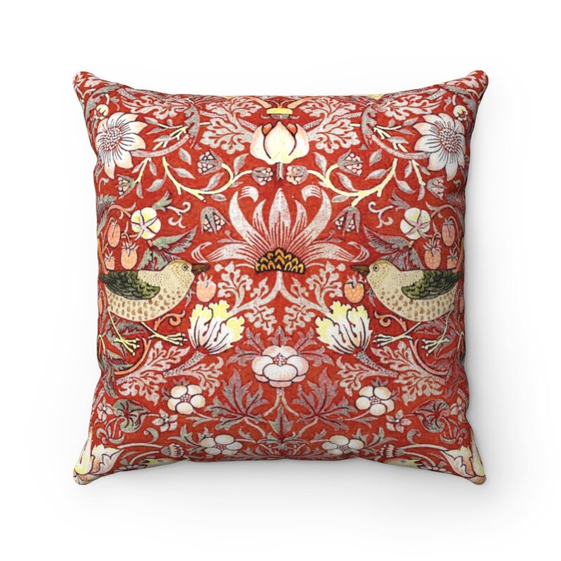May include: Red throw pillow with a floral pattern featuring birds and leaves. The pattern is reminiscent of a vintage wallpaper design.