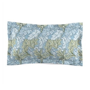 May include: A rectangular pillowcase featuring a repeating pattern of stylized leaves in shades of blue, green, and white. The leaves have a detailed, textured appearance, set against a light blue background. The pillowcase is a bedding item.
