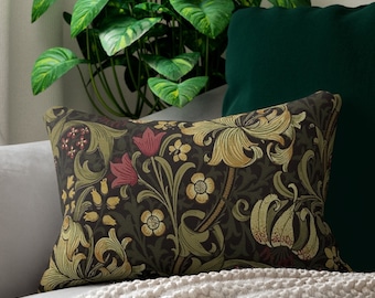 May include: A decorative cushion with a dark green background and a floral pattern in shades of yellow, red, and green. The pattern features stylised lilies and leaves.