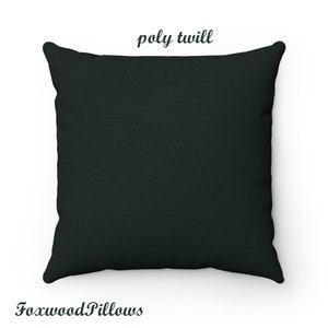 May include: A dark green square pillow with the text "poly twill" printed in white on the top.
