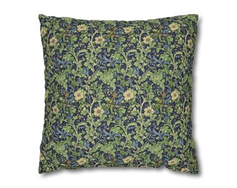 Pode incluir: Uma almofada quadrada com um padrão floral. A almofada apresenta um fundo azul escuro com folhas verdes e flores amarelas.