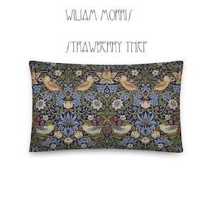 May include: A decorative pillow featuring a William Morris Strawberry Thief design. The pillow is navy blue with a repeating pattern of birds, flowers, and leaves in shades of green, yellow, red, and blue.