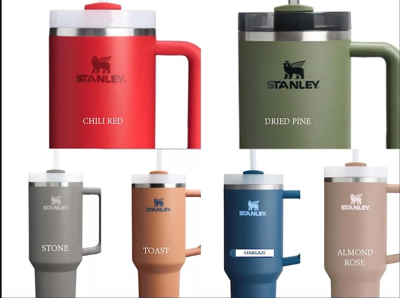 May include: Six Stanley brand insulated travel mugs with lids and handles. The mugs are in various colours: chili red, dried pine, stone, toast, stargaze, and almond rose.