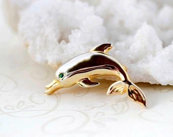 Broche vintage de delfín dorado: ojo de cristal esmeralda, joyería de los años 80-90