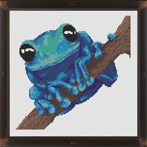 May include: A blue and green frog with large black eyes sits on a brown branch. The frog is facing the right side of the image.