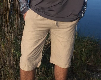 May include: A pair of beige linen shorts with a drawstring waist.