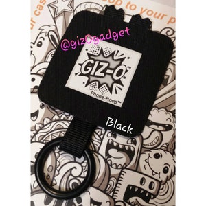 May include: Black phone hoop with a white GIZ-O logo and the text "Phone-Hoop™". The hoop is attached to a black strap with a metal ring.