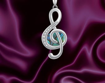 A Silver Treble Clef On Top Of Music Sheets Stock Image - Image Of