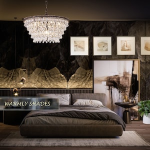 May include: A bedroom with a large bed, a crystal chandelier, and a dark brown wall with a large abstract painting. The bed has a brown headboard and a brown and white patterned comforter. There is a small table next to the bed with a plant on it. The text "Warmly Shades" is visible in the lower left corner of the image.