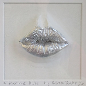 May include: A silver-colored sculpture of a pair of lips, titled "A Precious Kiss by Steve Yeates 1/100".