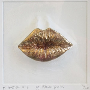 May include: A golden sculpture of a pair of lips, titled "A Golden Kiss" by Steve Yeates, with the edition number 3/100.