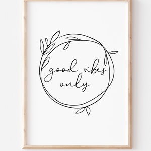 May include: A black and white printable wall art print with a floral wreath and the text "good vibes only".