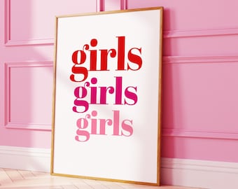 May include: A framed print with the word "girls" repeated three times in different shades of pink and red on a white background.