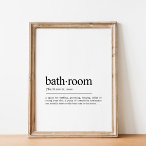 May include: A framed print with a black and white definition of the word "bathroom". The definition reads: "['ba:th:room] noun a space for bathing, grooming, singing, relief of losing your shit. a place of contention sometimes and usually home to the best seat in the house."