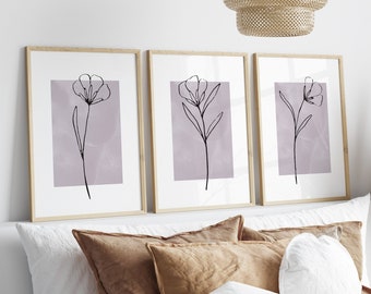 May include: Three framed prints featuring a minimalist line drawing of a flower on a pale purple background.