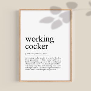May include: A black and white printable poster with the definition of a "working cocker" dog breed. The poster has a brown wood frame and a shadow of a leaf in the background.