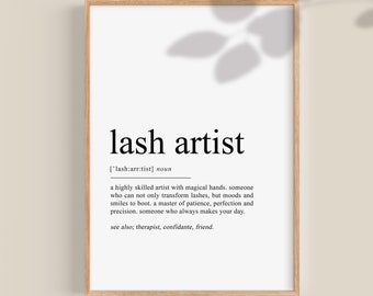 May include: A printable definition of the term "lash artist" in a white frame with a wood-like border. The definition reads: "a highly skilled artist with magical hands. someone who can not only transform lashes, but moods and smiles to boot, a master of patience, perfection and precision. someone who always makes your day. see also; therapist, confidante, friend."