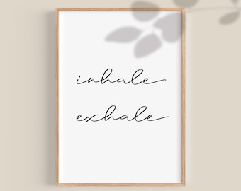 May include: A white framed print with black calligraphy that reads "inhale exhale" on a light beige background.