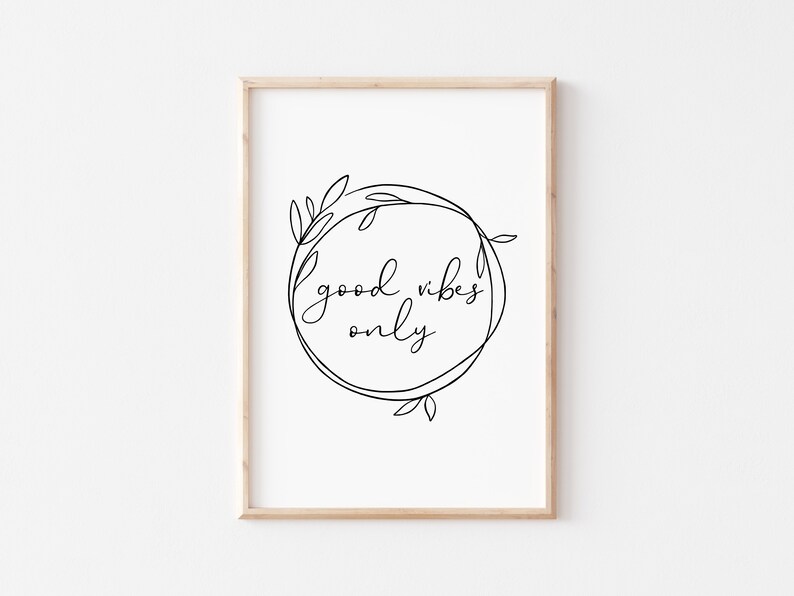 May include: A black and white printable wall art print with a floral wreath and the text "good vibes only".