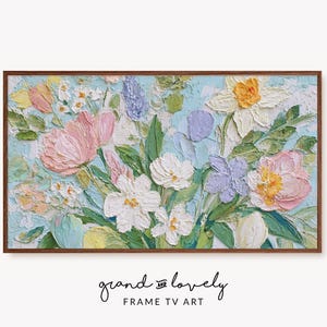 May include: A framed floral painting with a textured, impasto style. The artwork features a bouquet of flowers in shades of pink, white, yellow, and purple against a light blue background. The frame is a dark brown color. The text "grand and lovely FRAME TV ART" is at the bottom.