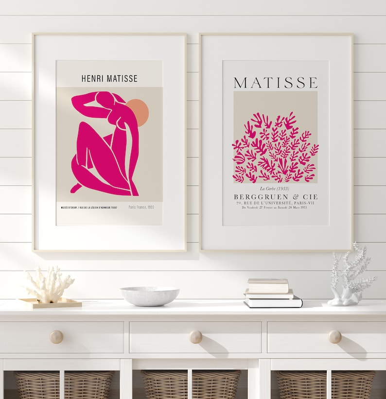 May include: Two framed prints of Matisse artwork. The left print features a pink figure with a sun in the background. The right print features a cluster of pink leaves. The text on the prints reads "Henri Matisse" and "Matisse".