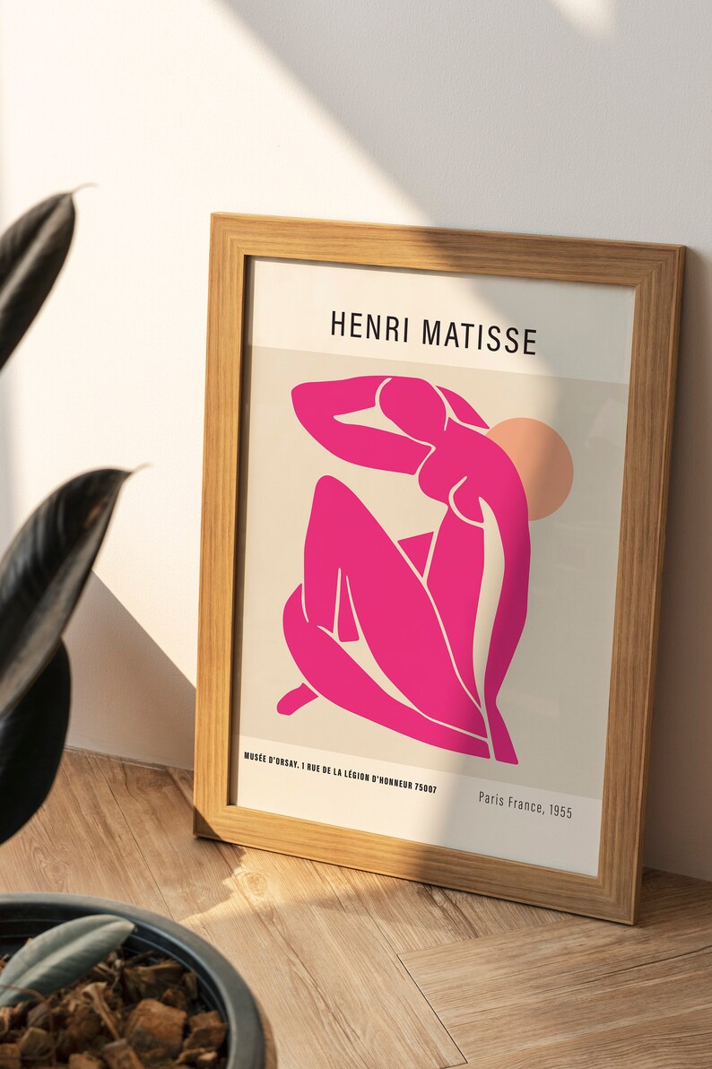 May include: A framed print of a pink abstract figure by Henri Matisse. The print is titled "Musee d'Orsay, 1 Rue de la Legion d'Honneur 75007" and "Paris France, 1955".