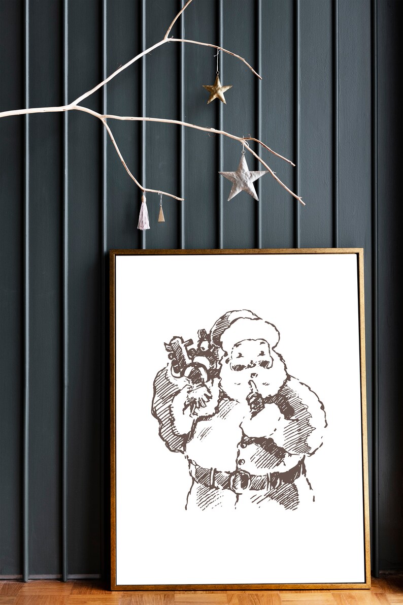 May include: A framed black and white illustration of Santa Claus holding a bag of gifts and putting a finger to his lips. The illustration is on a white background.