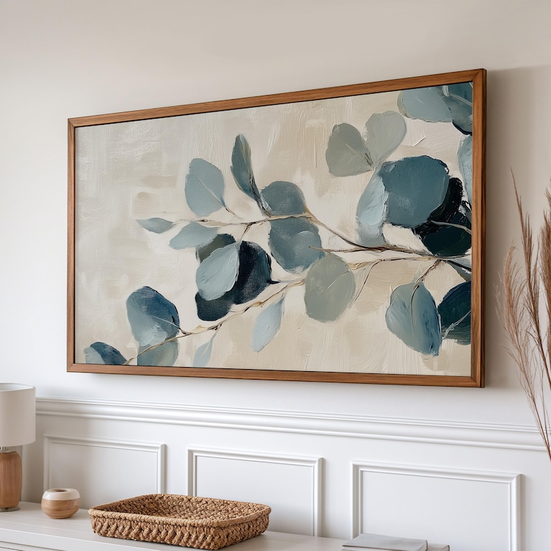 May include: A framed abstract painting featuring a branch of blue-green leaves on a cream background.