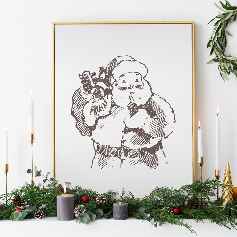 May include: A framed black and white sketch of Santa Claus holding a bag of gifts. The frame is gold and the sketch is on a white background. The image is surrounded by a garland of green pine branches with red berries and pine cones.