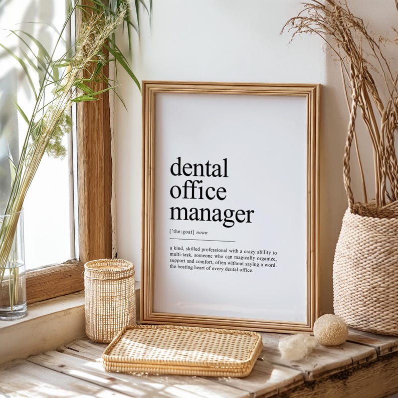 May include: A black and white printable art print with the text "dental office manager [the goat] noun" and a definition of the term. The print is framed in a light wood frame and is sitting on a wooden surface.