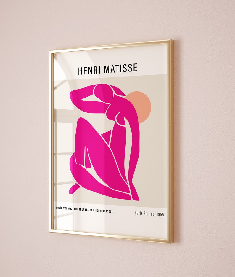 May include: A framed print of a pink abstract figure by Henri Matisse. The print is titled "MUS&Eacute;E D'ORSAY I RUE DE LA LEGION D'HONNEUR 75007" and "Paris France, 1955".
