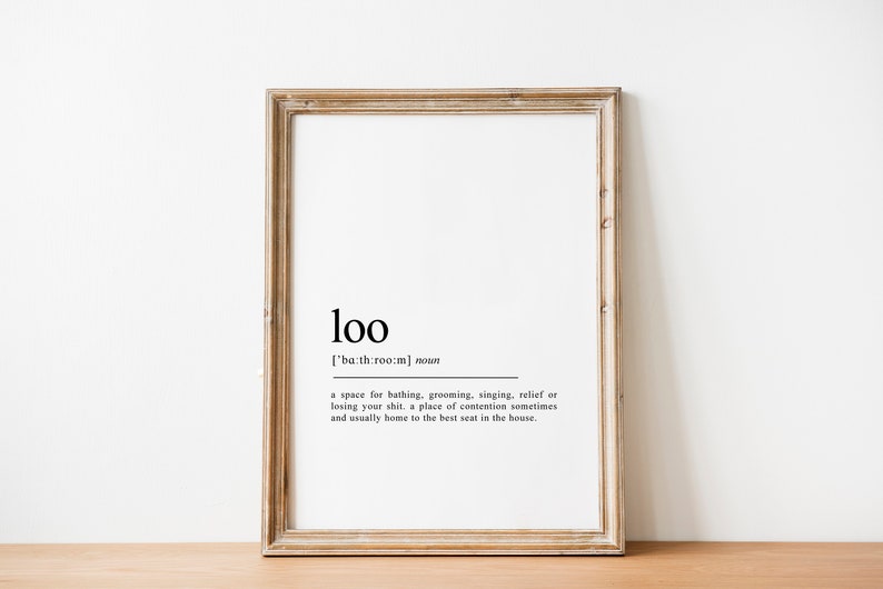 May include: A framed print with the word "loo" defined as a space for bathing, grooming, singing, relief, or losing your shirt. The definition also states that it is a place of contention sometimes and usually home to the best seat in the house.