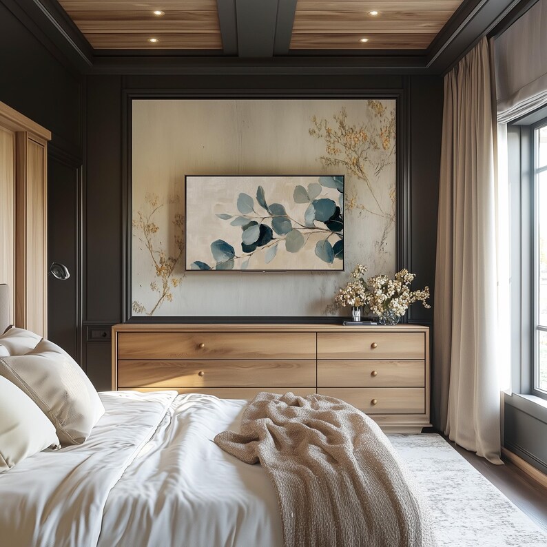 May include: A bedroom with a wooden dresser, a bed with white linens and a beige throw blanket, and a large framed print of a leafy design above the dresser. The room has a dark wood ceiling and light brown curtains.