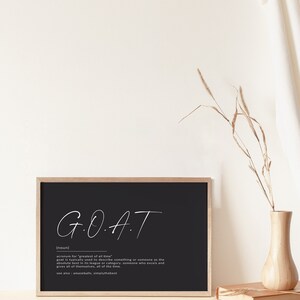 May include: Black and white printable wall art with the acronym GOAT, which stands for "greatest of all time". The definition of GOAT is written below the acronym.